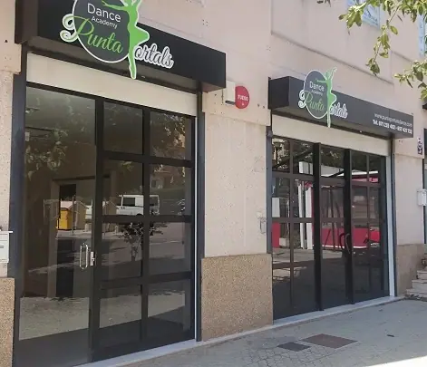 Punta Portals Dance studio entrance with its green logo sign above the glass doors
